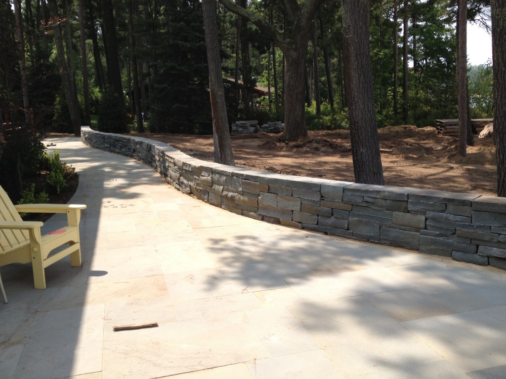 short stone wall along smooth paved walkway