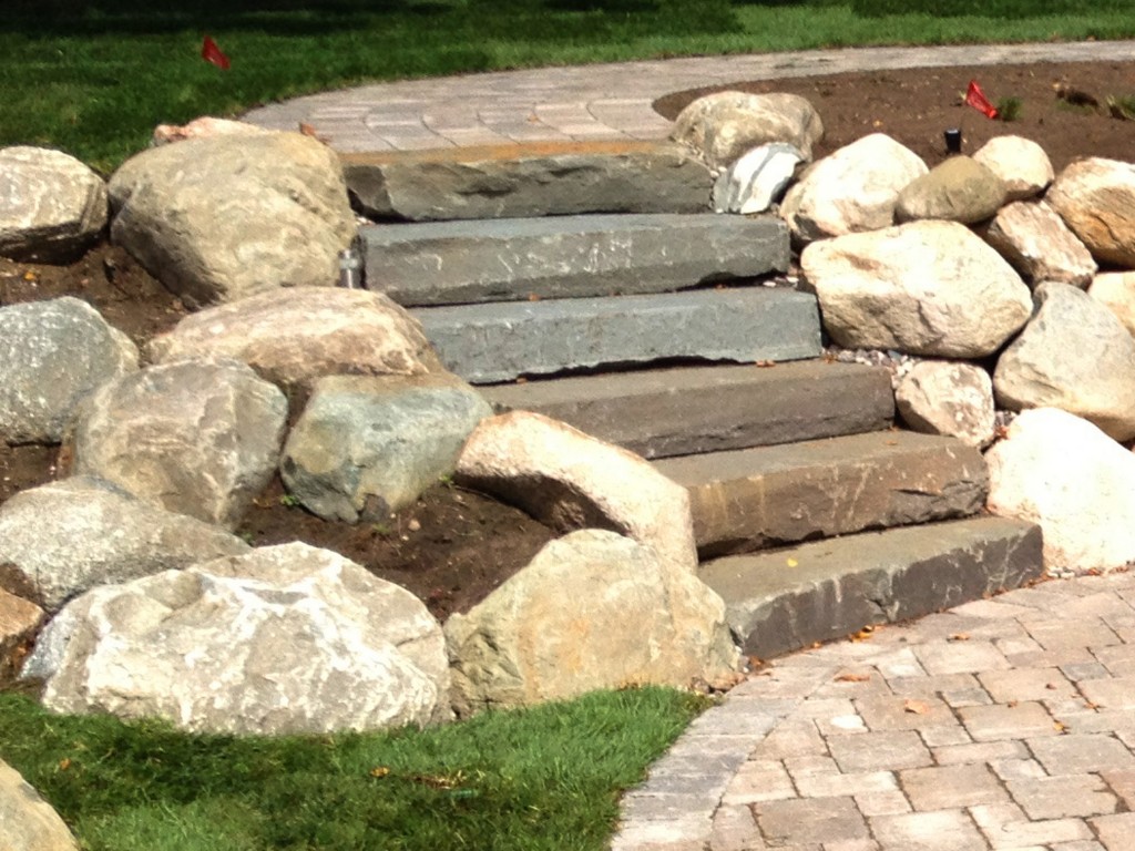 tiered path with large rock retaining wall