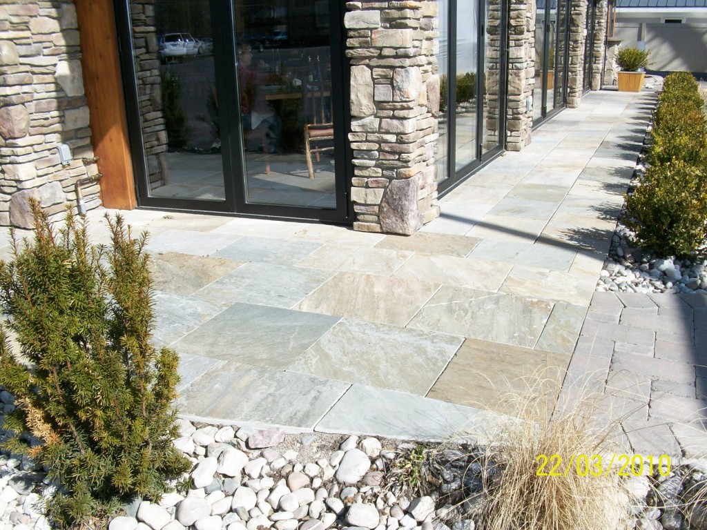 smooth flag stone paths with rock column pillar building facade