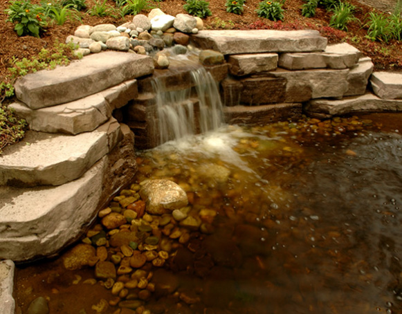 tiered rock waterfall draining into pond
