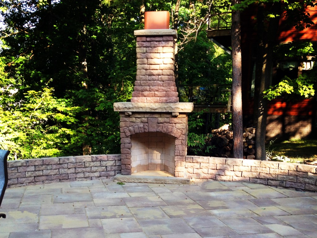 outdoor brick fireplace on patio
