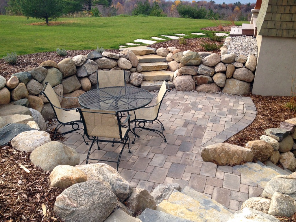 retaining wall of large stones with mulch topper
