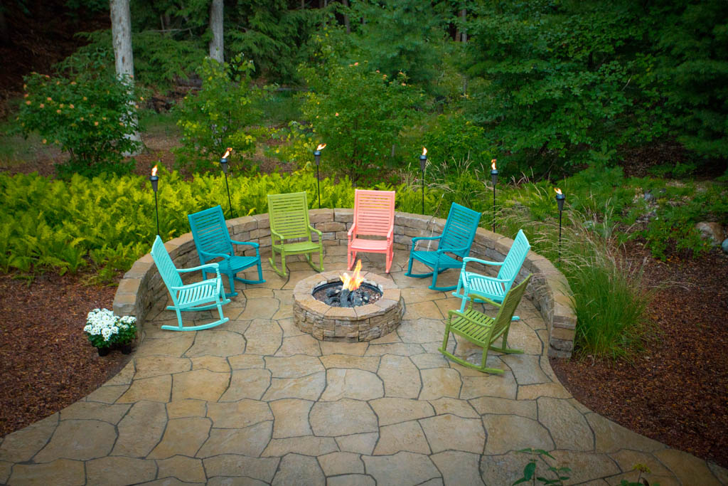 aerial view of multi colored rocking chairs on patio with fire place