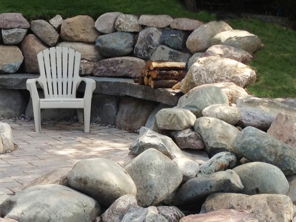 white plastic lawn chair on stone patio