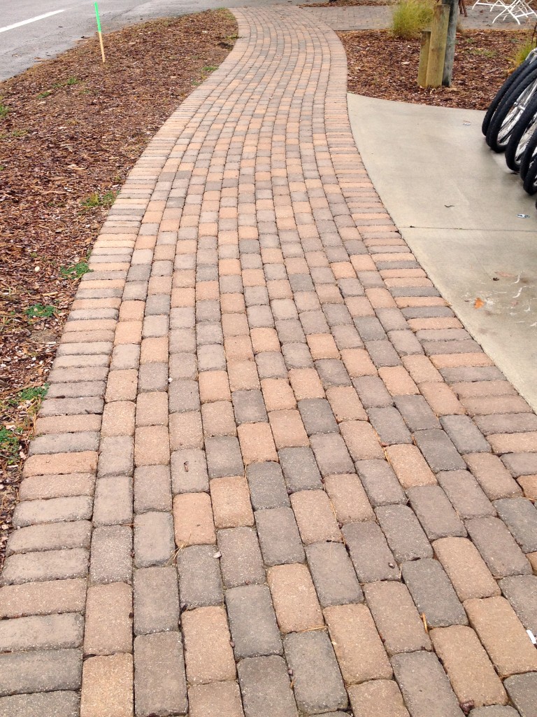 walkway with light red brick pavers
