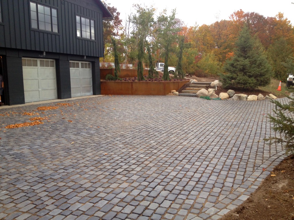 gray stone paved driveway with autumn leaves