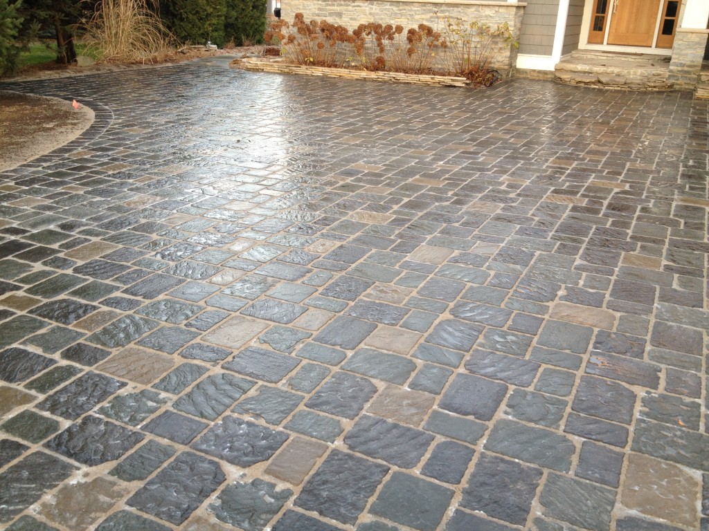 multi colored grouted paved entryway in front of door 