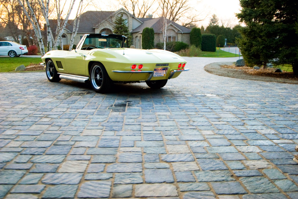 yellow convertible vehicle parked in residential driveway