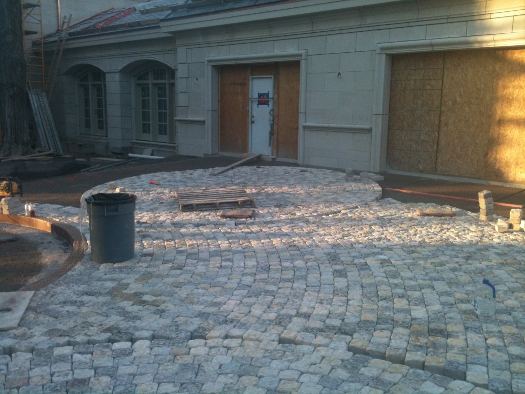 small square stones laid in circular pattern outside of home's front door