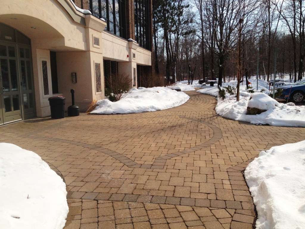 snow covered brick surface with inlay pattern 