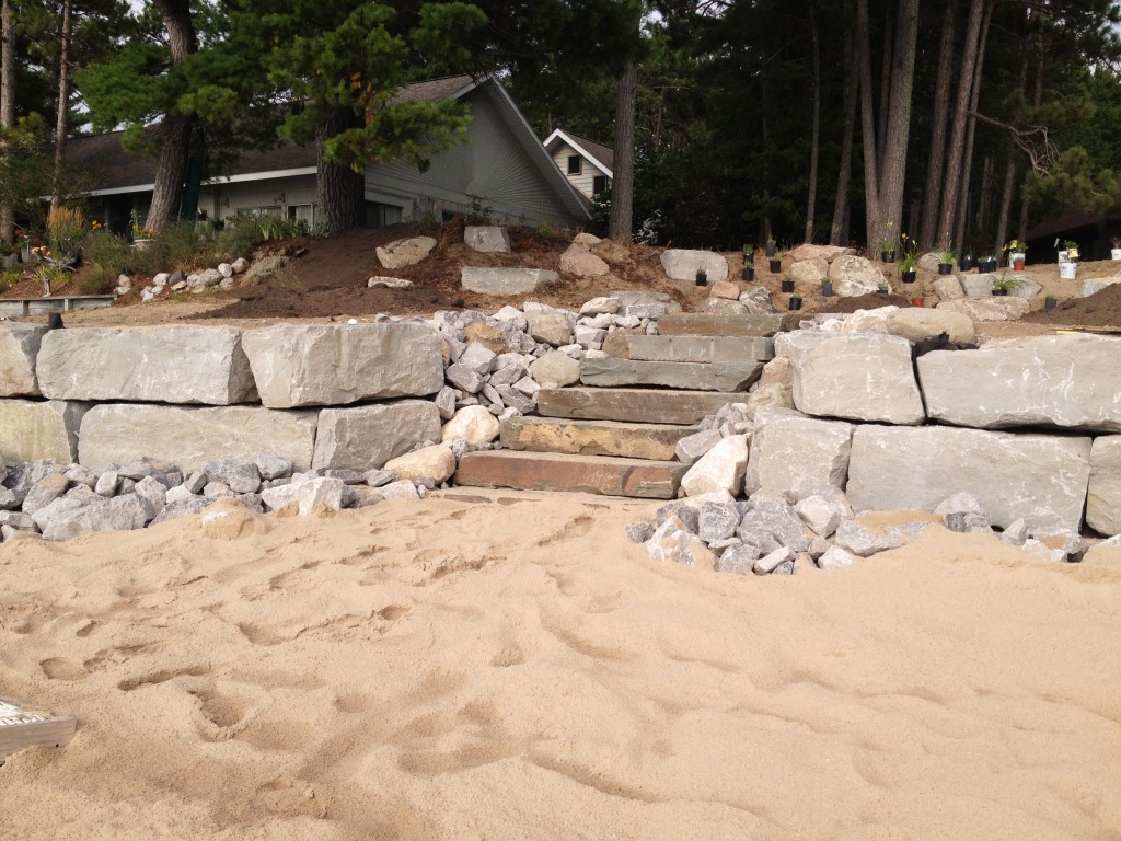 landscaped steps leading down to a sandy beach