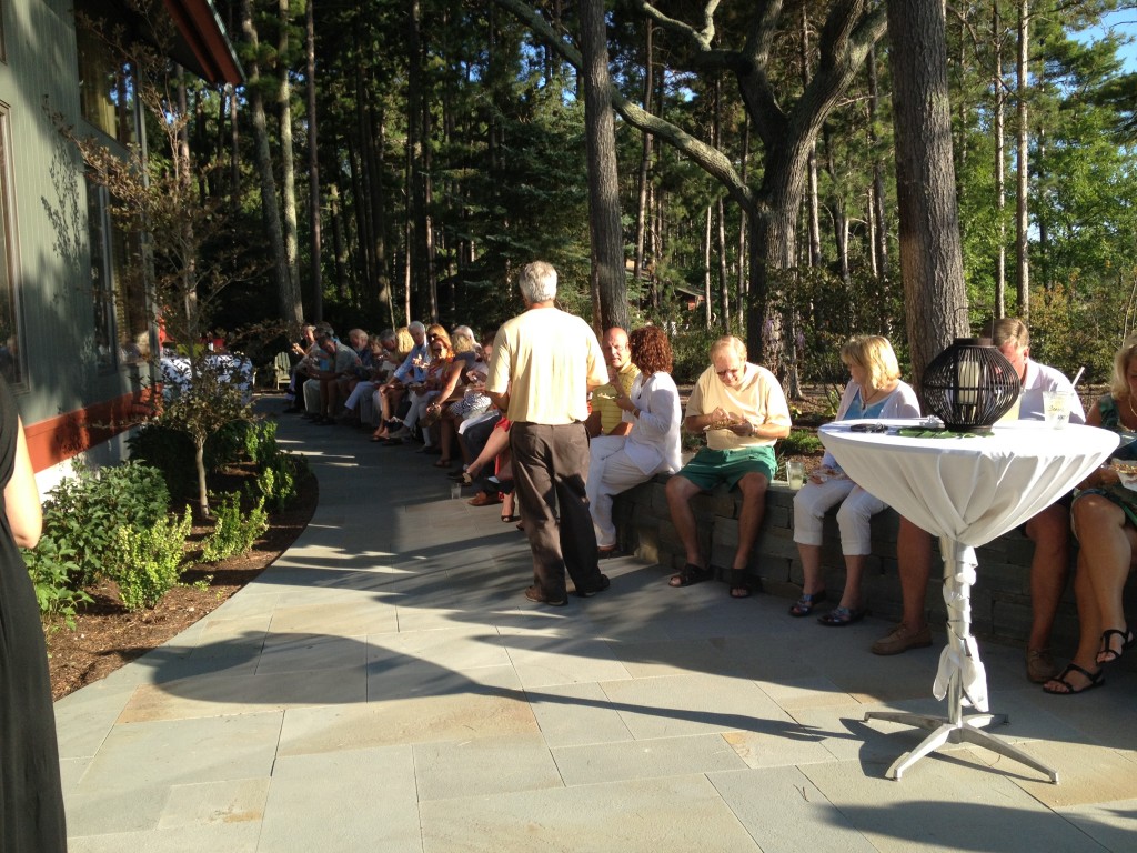 group gathering using retaining wall as seating