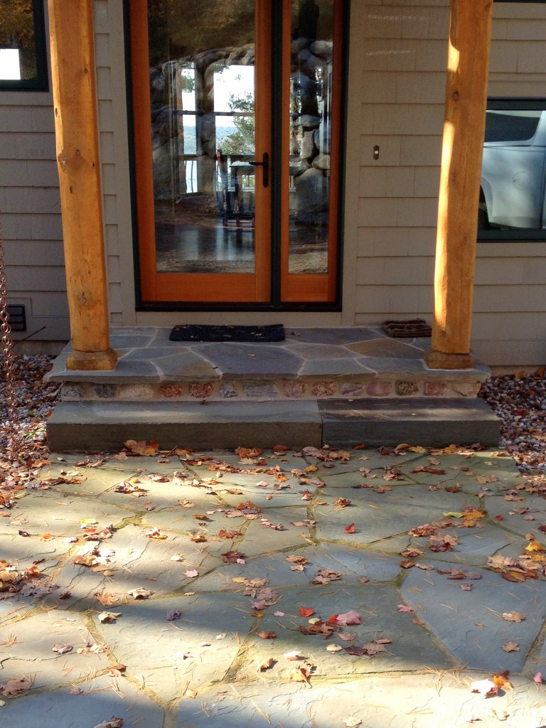 flat stone porch with natural wood beam pillars