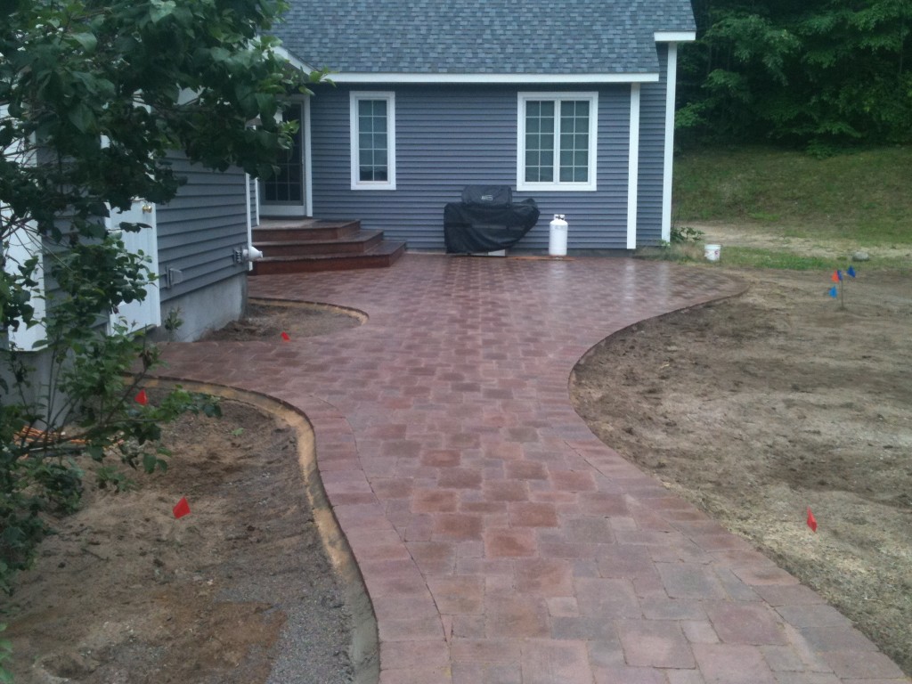 red brick curvy pathway in front of residence