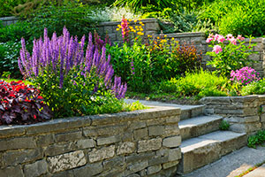 flowers atop retaining wall feature