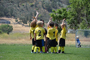 kids playing soccer at the park