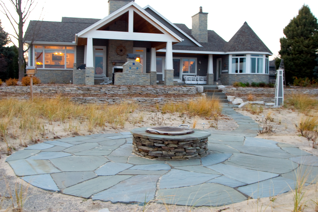 beach patio fire place in front of residence 