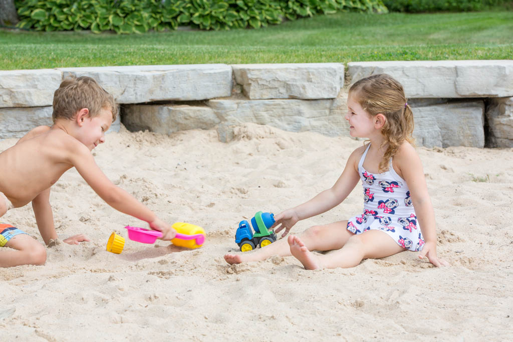 boy and girl playing in the sand