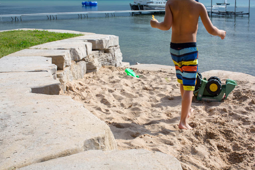 boy walking in the sand