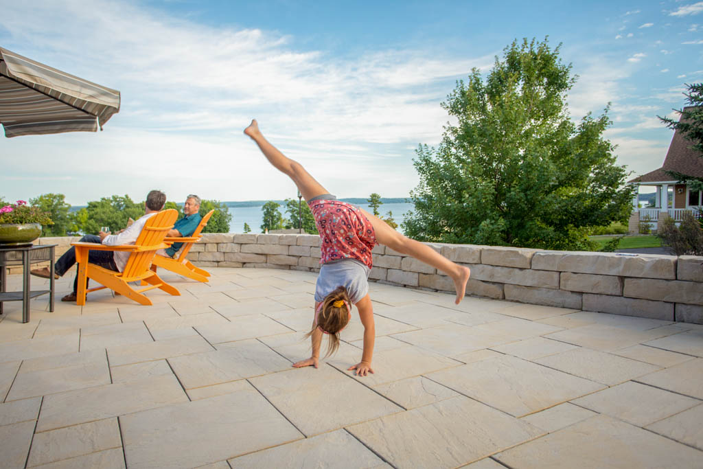 kid doing handstand with view of lake