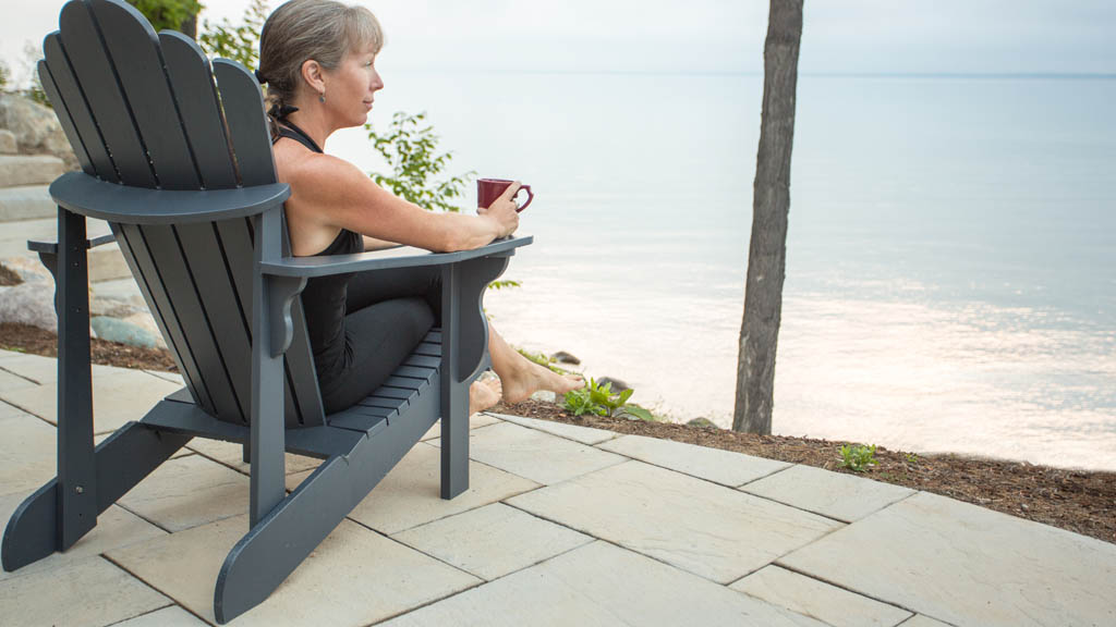 lady enjoys morning coffee by the water