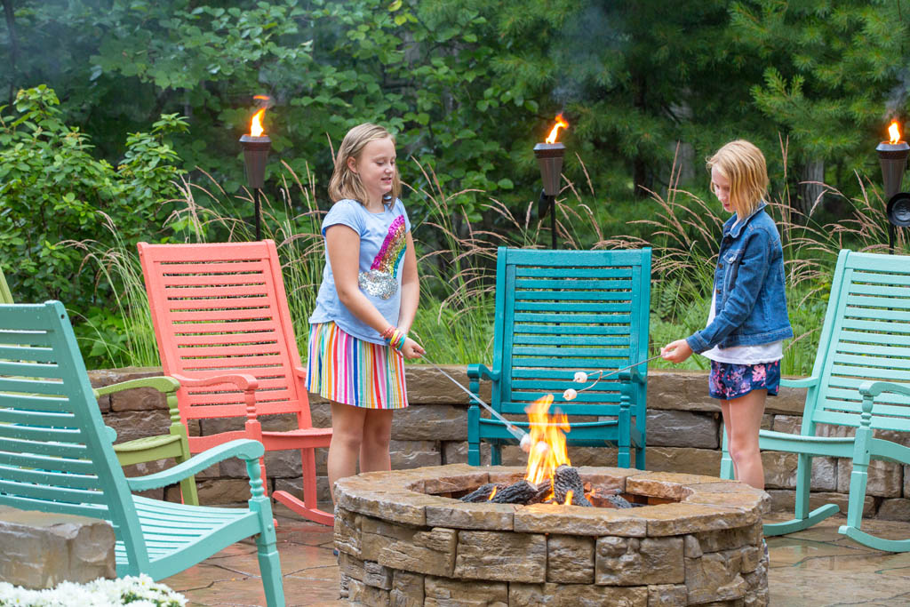 two girls roasting marshmallows over fire