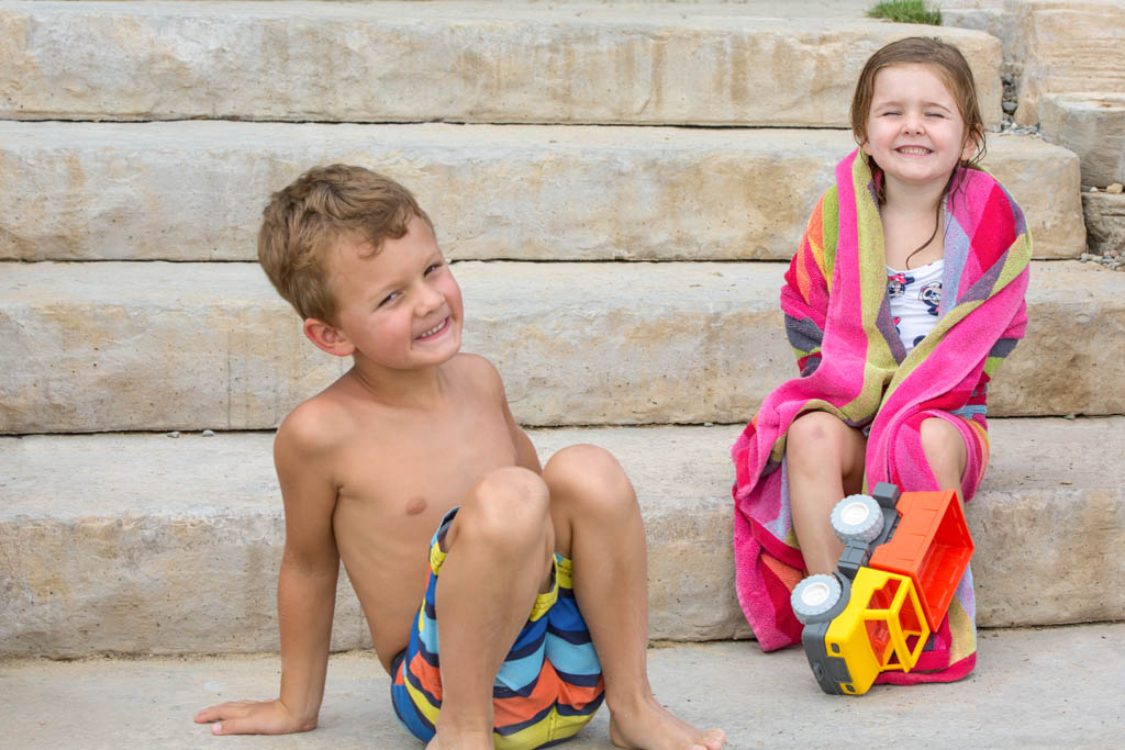 boy and girl dry off after getting otu of the water